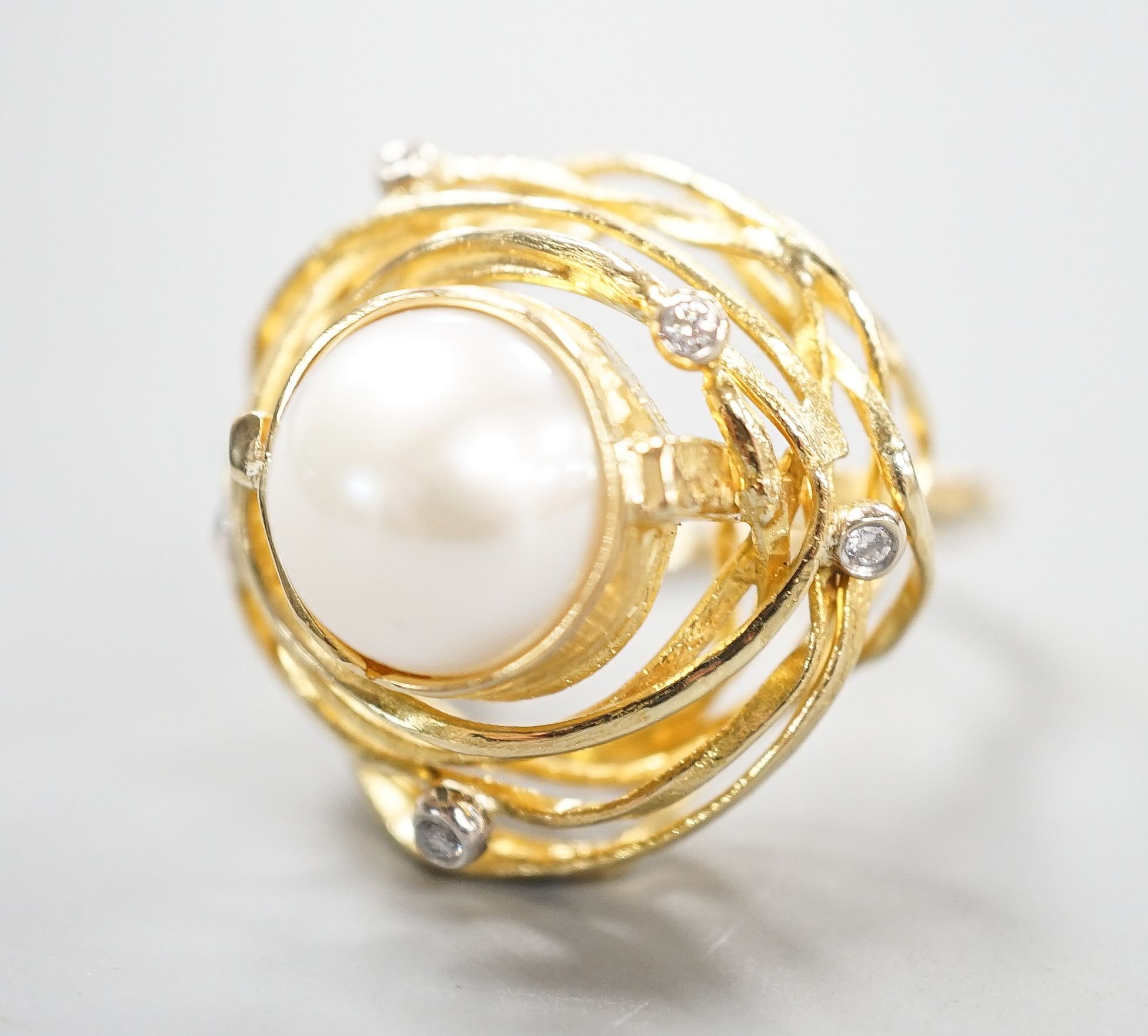 A modern 750 yellow metal, mabe pearl and diamond chip set modernist dress ring, size Q, gross 13.2 grams.